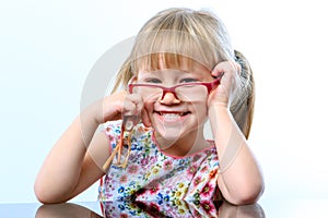 Funny little girl wearing glasses.