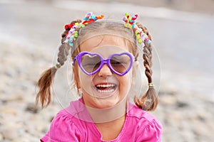 Funny little girl wearing a sunglasses