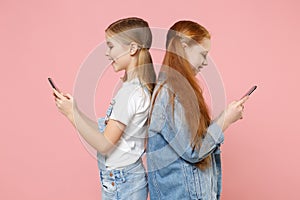 Funny little kids girls 12-13 years old in denim clothes isolated on pink background. Childhood lifestyle concept. Mock