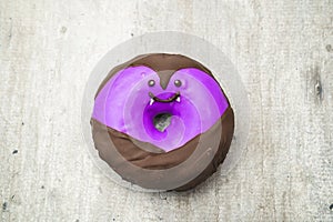 Funny little monster donut for halloween bright colors with little eyes