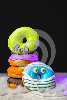 Funny little monster donut for halloween bright colors with little eyes