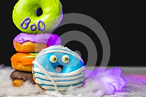 Funny little monster donut for halloween bright colors with little eyes