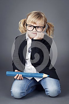 Funny little nerd holding big coloring pencil