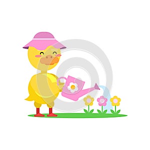 Funny little yellow duckling wearing pink hat watering flowers