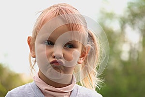 Funny llittle girl blonde at a loss