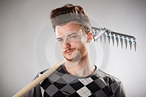 Funny looking guy with red-haired with a rake