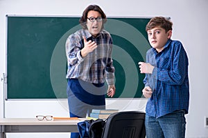 Funny male teacher and boy in the classroom