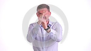 Funny male worker makes faces standing on white background