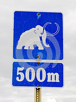 Funny mammoth symbol on road sign