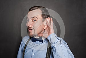 Funny man with big ear overhear on blackboard