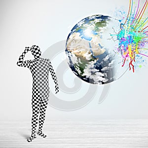 Funny man in body suit looking at colorful splatter earth