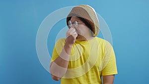 Funny man closing his nose, smells something bad