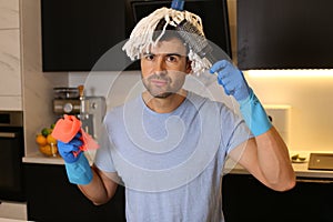 Funny man combing his mop hair