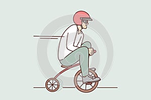 Funny man drives miniature bicycle while rushing to meeting or relaxing in spare time
