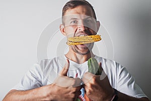 funny man eating corn on a white background