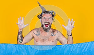 Funny man with foam on head taking shower. Bearded guy washing in bath.