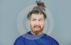 Funny man at the hairdresser getting a haircut. Hipster client in hairdressing salon. Professional barber styling hair