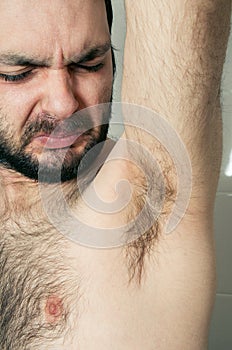 Funny man having bad smell from armpit