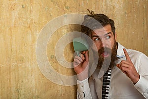 Funny man hear gossip with cup. Excited guy listen at wall. Man listening through the wall with the cup. Secrets and