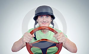 Funny man in helmet with steering wheel, car drive concept