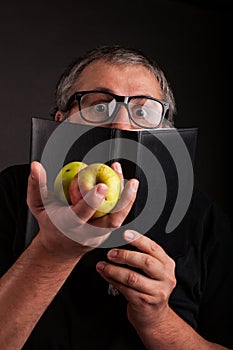 Funny Man hides behind big sleek leather book