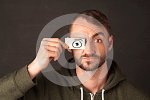 Funny man looking with hand drawn paper eyes