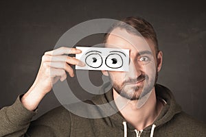 Funny man looking with hand drawn paper eyes