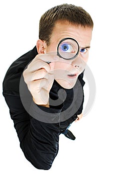 Funny man looking through a magnifying glass.