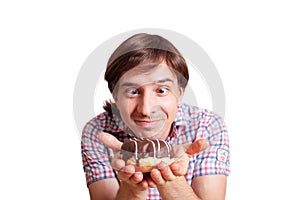 Funny man looks at the chocolate doughnut bulging eyes