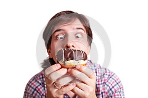 Funny man looks at the chocolate doughnut bulging eyes