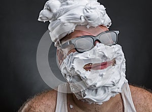 Funny man with shaving foam covered face