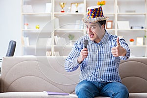 The funny man singing songs in karaoke at home