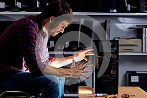 Funny man using magic skills while repairing a computer