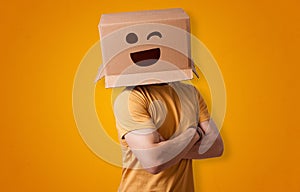 Funny man smiling with cardboard box head photo
