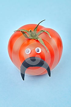 Funny manlike tomato with moustache. photo