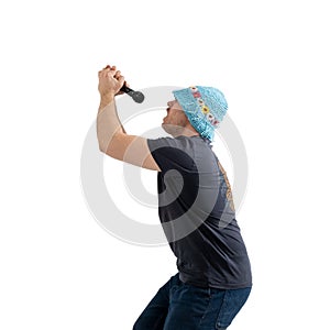 A funny mature man in a bright hat holds a microphone in his hands. Isolated on a white background