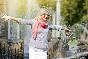 Funny Mature Middle Aged Smiling Blond Woman Wearing Spectacles Posing Outdoors in Park.