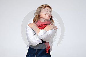 Funny mature woman hugging herself being selfish.