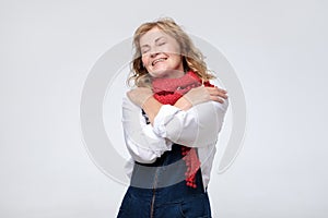 Funny mature woman hugging herself being selfish