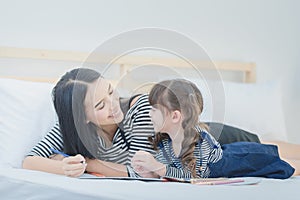 Funny mom and lovely child having fun together.Photo design for