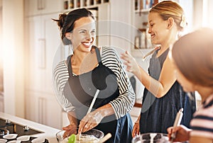 Funny mother, happy family or kids baking in kitchen with siblings learning cookies recipe or mixing pastry. Laughing