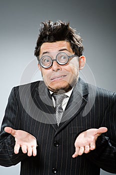 The funny nerd businessman in dark studio