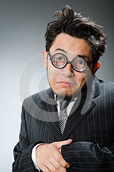 The funny nerd businessman in dark studio