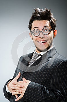 Funny nerd businessman in dark studio