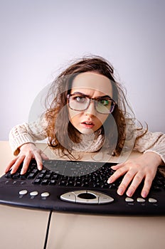 Funny nerd girl working on computer