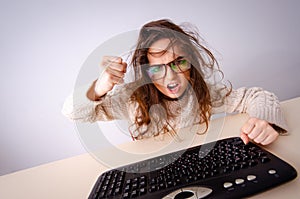 Funny nerd girl working on computer