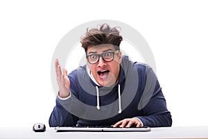 The funny nerd man working on computer isolated on white