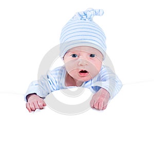 Funny newborn baby boy playing on his tummy