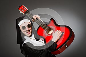 The funny nun with red guitar playing