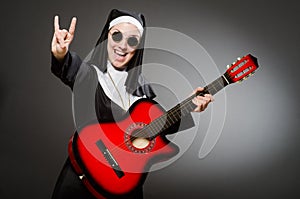 The funny nun with red guitar playing